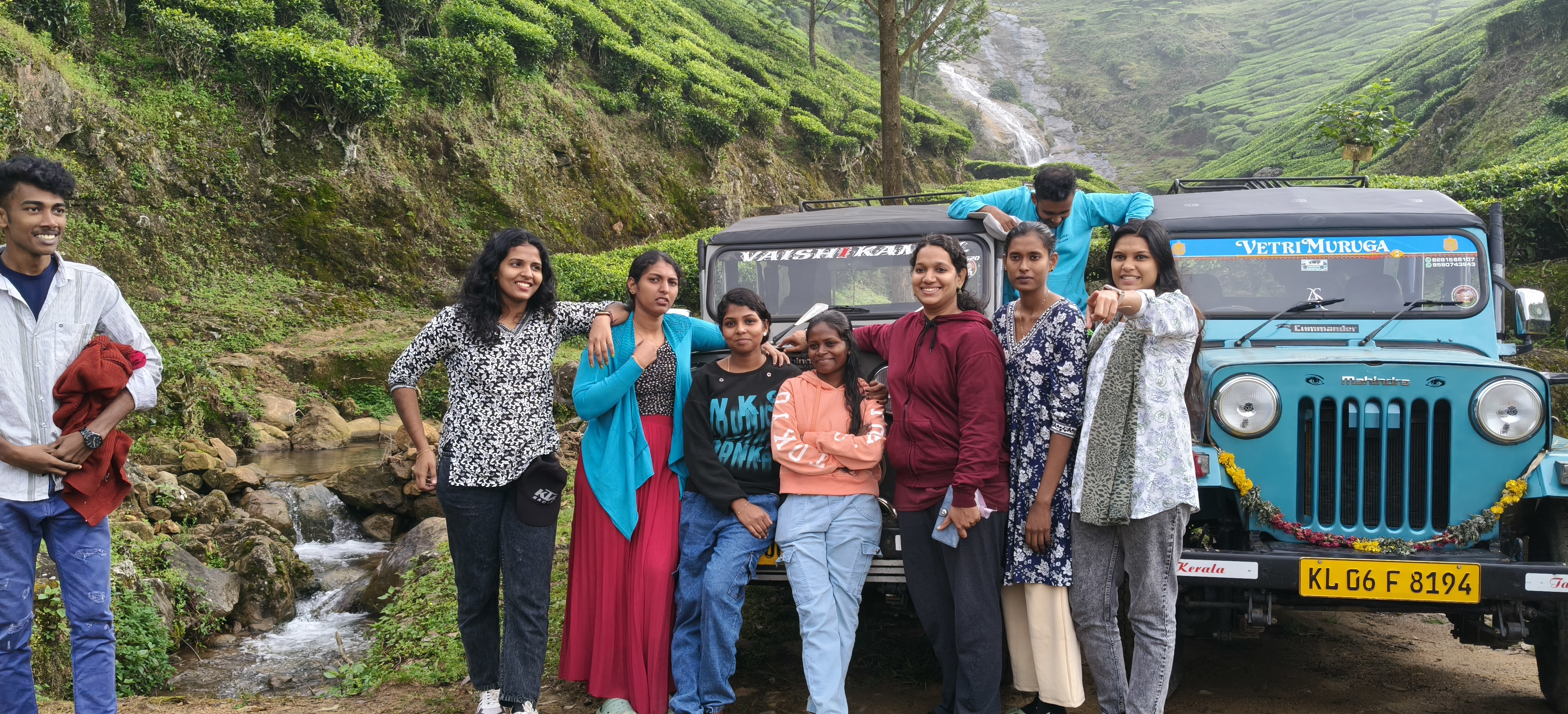 Kolukkumalai Sunrise Point group picture in front of jeep and green tea estate